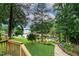 Backyard view of lush greenery and lake access at 106 Palomino Cv, Louisburg, NC 27549