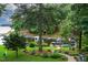 Backyard view of lush greenery and lake access at 106 Palomino Cv, Louisburg, NC 27549