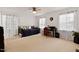 Bright bedroom with large windows, daybed, ceiling fan and a desk area at 106 Palomino Cv, Louisburg, NC 27549