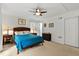 Cozy bedroom with ceiling fan, neutral carpet, and a view of the doorway at 106 Palomino Cv, Louisburg, NC 27549