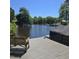 Wooden dock with a bench overlooking the serene lake and boats docked along the shoreline at 106 Palomino Cv, Louisburg, NC 27549