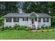 Charming home featuring a well-manicured lawn, and inviting front porch at 106 Palomino Cv, Louisburg, NC 27549