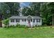 Charming single-story home with a well-kept lawn, and inviting front porch at 106 Palomino Cv, Louisburg, NC 27549