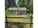 Charming one-story home with gray siding, black shutters and a well-manicured front yard and garden at 106 Palomino Cv, Louisburg, NC 27549