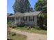 Well maintained one-story house, gray siding, black shutters, front yard with stone driveway at 106 Palomino Cv, Louisburg, NC 27549