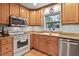 Functional kitchen featuring stainless steel appliances and a sink with a view at 106 Palomino Cv, Louisburg, NC 27549