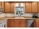 Efficient kitchen layout with stainless steel dishwasher and view out the window at 106 Palomino Cv, Louisburg, NC 27549