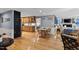 Open concept living room flows into dining area and kitchen with hardwood floors and a modern design at 106 Palomino Cv, Louisburg, NC 27549