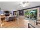 Spacious living room with large windows, a ceiling fan, and access to a deck at 106 Palomino Cv, Louisburg, NC 27549
