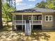 View of the backyard deck showcasing ample space and stairs leading to the grassy area at 107 Seminole Dr, Louisburg, NC 27549