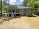 Expansive backyard view of the home with a spacious deck and steps leading down to the yard at 107 Seminole Dr, Louisburg, NC 27549