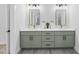 Beautiful bathroom with double sinks, decorative mirrors, and modern lighting at 107 Seminole Dr, Louisburg, NC 27549