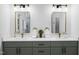 Dual sink bathroom with decorative hardware, light fixtures, and modern cabinetry at 107 Seminole Dr, Louisburg, NC 27549