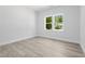 Bright bedroom featuring sleek flooring, ample natural light, and modern paint at 107 Seminole Dr, Louisburg, NC 27549