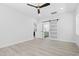 Bedroom with ceiling fan provides access to ensuite bathroom and a barn door closet at 107 Seminole Dr, Louisburg, NC 27549