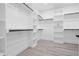 A spacious walk-in closet featuring custom shelving, wood poles, and modern flooring at 107 Seminole Dr, Louisburg, NC 27549