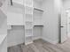 Walk-in closet boasts custom shelving and wooden rods for ample storage and organization at 107 Seminole Dr, Louisburg, NC 27549