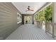 Spacious covered back deck with wood-look ceiling fan at 107 Seminole Dr, Louisburg, NC 27549