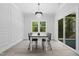 Dining room with chandelier, neutral walls, and large windows offer natural light and peaceful views at 107 Seminole Dr, Louisburg, NC 27549