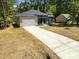 Charming home showcasing a long driveway and inviting curb appeal with green landscaping at 107 Seminole Dr, Louisburg, NC 27549