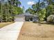Beautifully landscaped home with stone and siding details and a long drive at 107 Seminole Dr, Louisburg, NC 27549