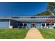 Exterior of blue building with white trim, outdoor seating, and a walkway to the grassy area at 107 Seminole Dr, Louisburg, NC 27549