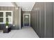 A modern, inviting porch with clean lines, sleek gray siding, and well-defined trim and windows at 107 Seminole Dr, Louisburg, NC 27549