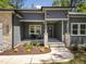 Inviting front porch with stone pillars, stylish lighting, and a comfortable seating area at 107 Seminole Dr, Louisburg, NC 27549