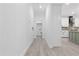 Hallway with views to laundry room and kitchen with white cabinets at 107 Seminole Dr, Louisburg, NC 27549