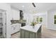 Modern kitchen with sleek white cabinets, granite countertops, stainless steel appliances, and a functional center island at 107 Seminole Dr, Louisburg, NC 27549