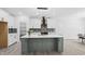 Modern open kitchen with an island, pendant lighting, stainless steel appliances, and plenty of countertop space at 107 Seminole Dr, Louisburg, NC 27549