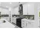 Stylish kitchen featuring white cabinets, sleek countertops, and stainless steel appliances, blending style and functionality at 107 Seminole Dr, Louisburg, NC 27549