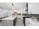 Bright open kitchen features a large island, stainless appliances, and stylish lighting at 107 Seminole Dr, Louisburg, NC 27549