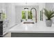 Close-up of kitchen with elegant faucet, white countertops, and ample natural light, perfect for culinary enthusiasts at 107 Seminole Dr, Louisburg, NC 27549