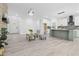 Bright open-concept living area showcasing fireplace, stylish seating, and easy access to kitchen and entry at 107 Seminole Dr, Louisburg, NC 27549