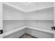 Spacious pantry featuring solid shelving and wood-look flooring at 107 Seminole Dr, Louisburg, NC 27549