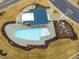 Aerial shot of the community pool and clubhouse and nearby playground at 1099 Channel Drop Lp, Zebulon, NC 27597