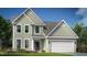Charming two-story home features a stone-accented facade and an attached two-car garage, perfect for a growing Gathering at 1099 Channel Drop Lp, Zebulon, NC 27597