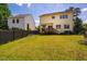 Beautifully maintained backyard with lush lawn, mature trees, wooden fence, and a deck, perfect for outdoor enjoyment at 11 Piccadilly Ct, Durham, NC 27713