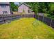 Spacious fenced backyard with a well-manicured lawn and a geometric play structure at 11 Piccadilly Ct, Durham, NC 27713