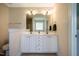 Bathroom featuring double sink vanity with white cabinets and a neutral color scheme at 11 Piccadilly Ct, Durham, NC 27713
