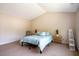 Spacious bedroom featuring neutral carpeting, vaulted ceilings, and light wood accents at 11 Piccadilly Ct, Durham, NC 27713