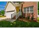 This home features brick accents, a well-manicured lawn, and an inviting entrance with brick steps and white railings at 11 Piccadilly Ct, Durham, NC 27713