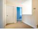 Hallway view into bedroom featuring carpeting and neutral color scheme at 11 Piccadilly Ct, Durham, NC 27713
