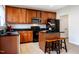 Kitchen with dark granite countertops, stainless steel appliances, and a center island with seating at 11 Piccadilly Ct, Durham, NC 27713