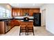 Well-lit kitchen featuring granite countertops, an island with seating, and stainless steel appliances at 11 Piccadilly Ct, Durham, NC 27713