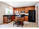 Kitchen with dark granite countertops, stainless steel appliances, and a center island with seating at 11 Piccadilly Ct, Durham, NC 27713