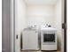 Cozy laundry room with modern washer and dryer, complemented by a practical wire shelf for storage at 11 Piccadilly Ct, Durham, NC 27713