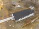 Aerial view of a home with a dark roof showing the driveway and fence bordering the property at 1101 Ridge Rd, Roxboro, NC 27573