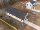 Aerial view of a home with a dark roof showing the driveway, surrounding yard and fence at 1101 Ridge Rd, Roxboro, NC 27573